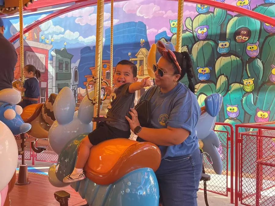 Luca and Tiana Ride the Carousel