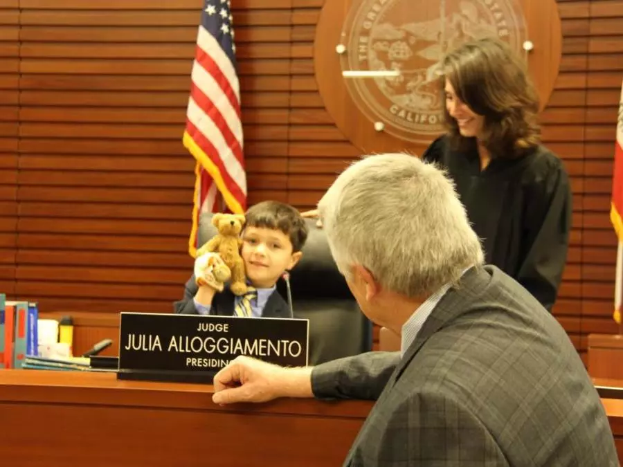 Judge Julia Alloggiamento offers her seat at the Bench to an adoptive family